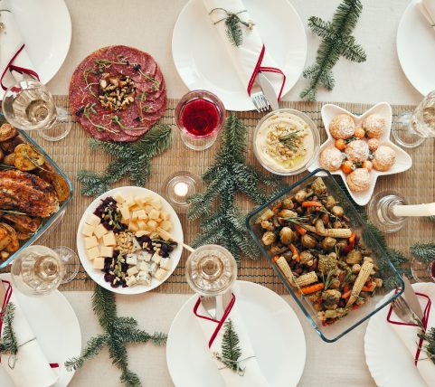 Top view background of beautiful dinner table decorated with fir branches set for Christmas banquet, copy space